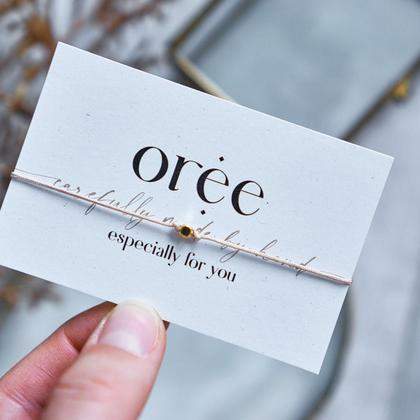 Beiges Armband mit kleiner Perle in Gold
